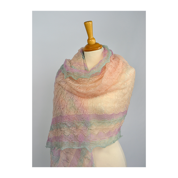 Multicolored shawl on a mannequin against a grey background