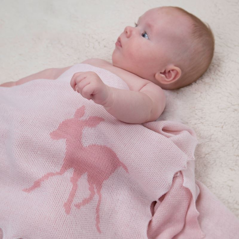 baby wrapped in pink fawn shawl