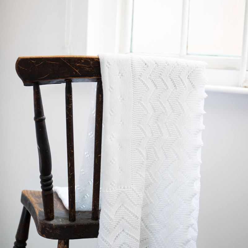 white lacy acrylic receiving shawl folded