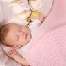 baby in crib with pink blanket