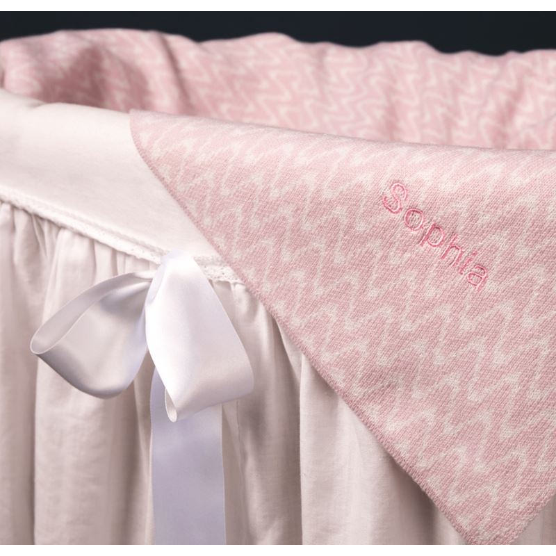 Pink cashmere baby blanket in basket