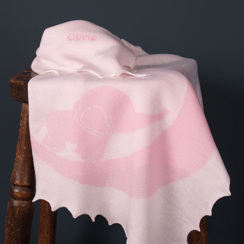 Pink baby elephant blanket on stool